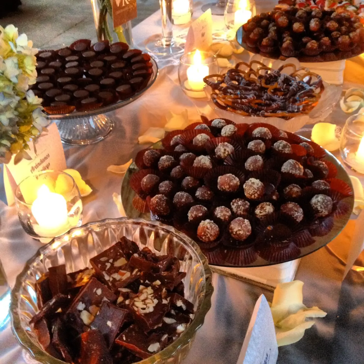 Chocolate truffles, chocolate-covered pretzels and other sweets on a dessert table