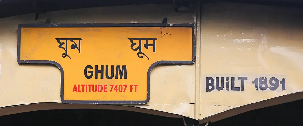 Station sign at Ghum railway station, India, in English and in Devanagari script
