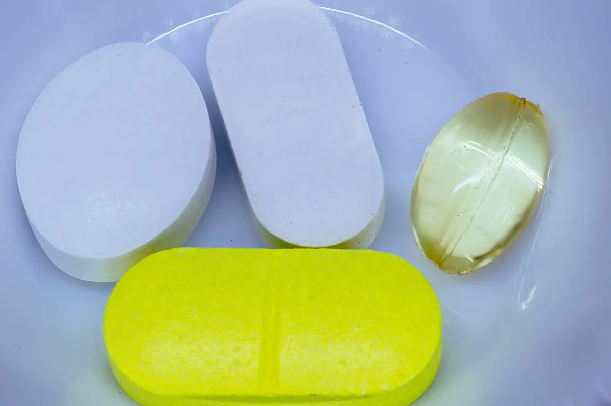 White and yellow tablets and a clear gel capsule