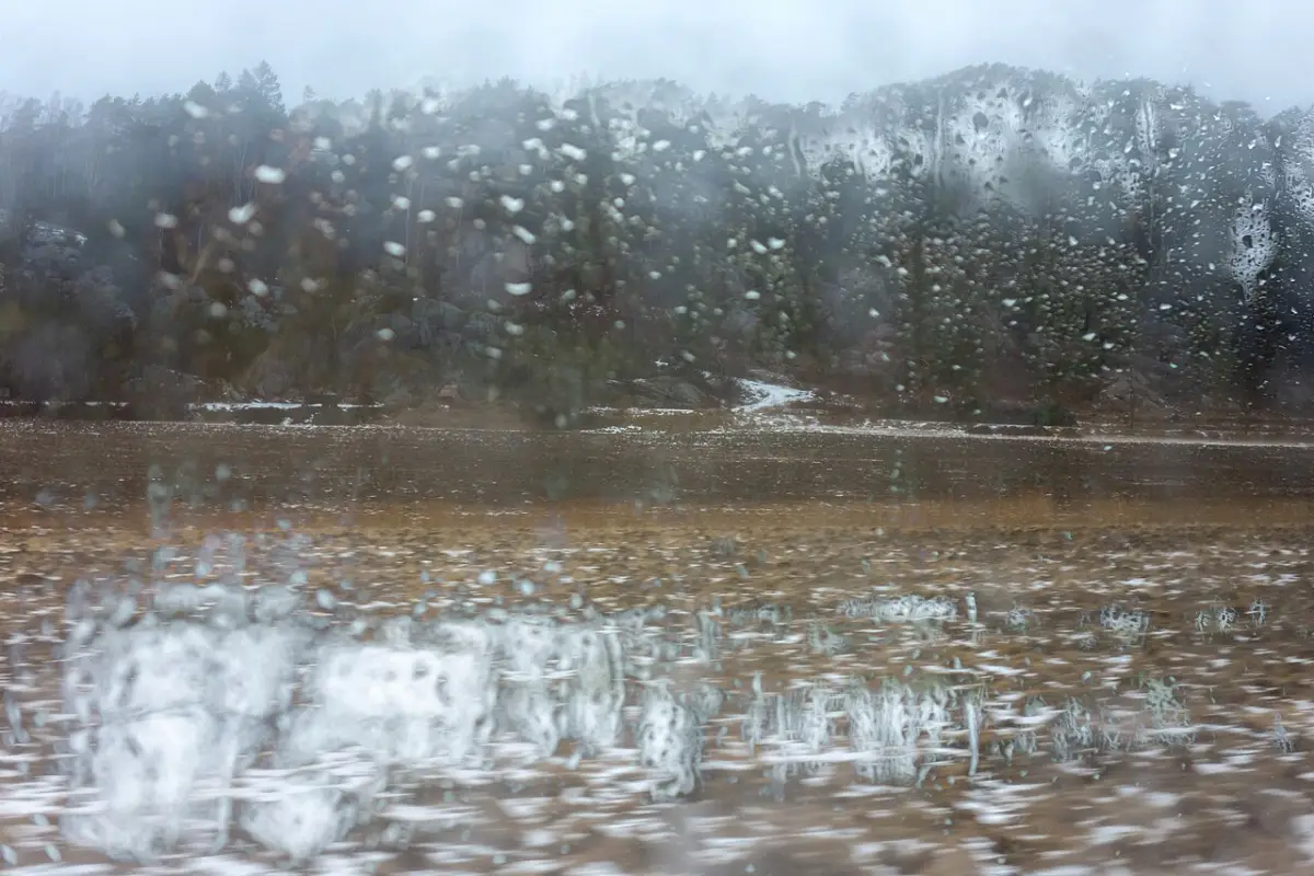 Rain on the window of a bus